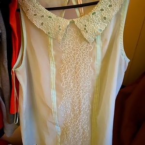 This is a light mint green shirt.